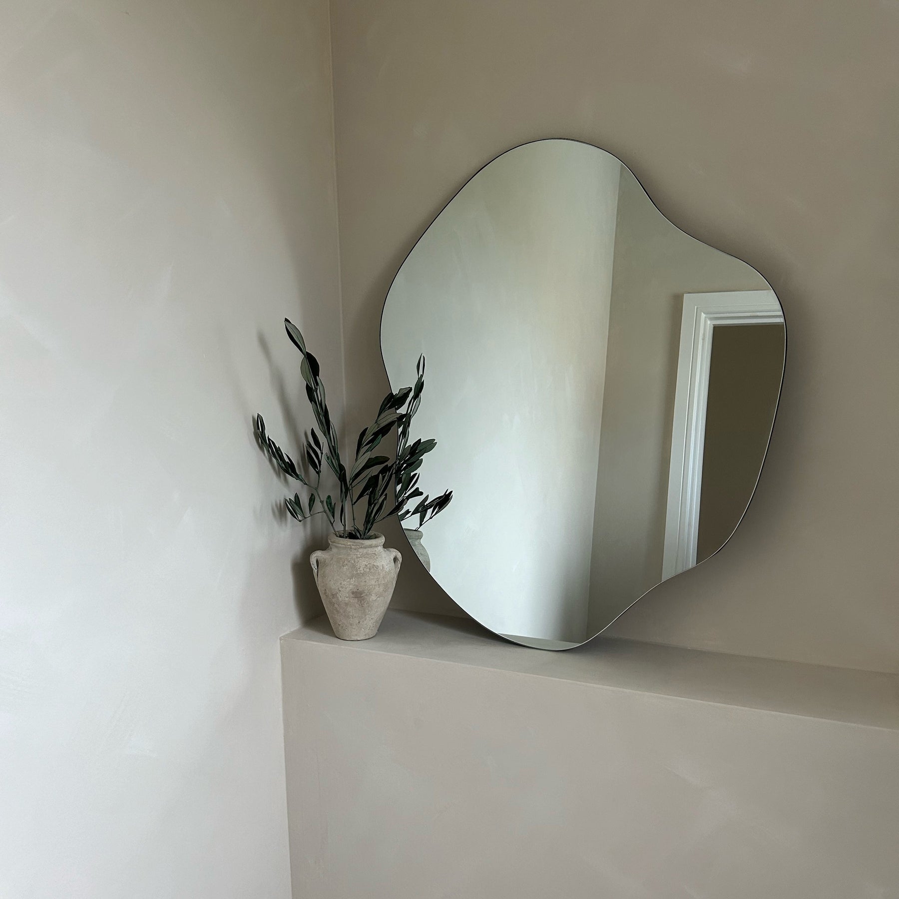 Small Frameless Pond Mirror leaning against bathroom wall