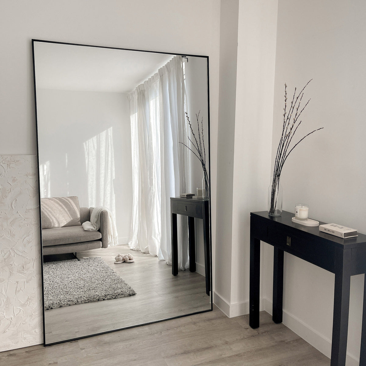 Full Length Black Extra Large Metal Mirror beside plinths