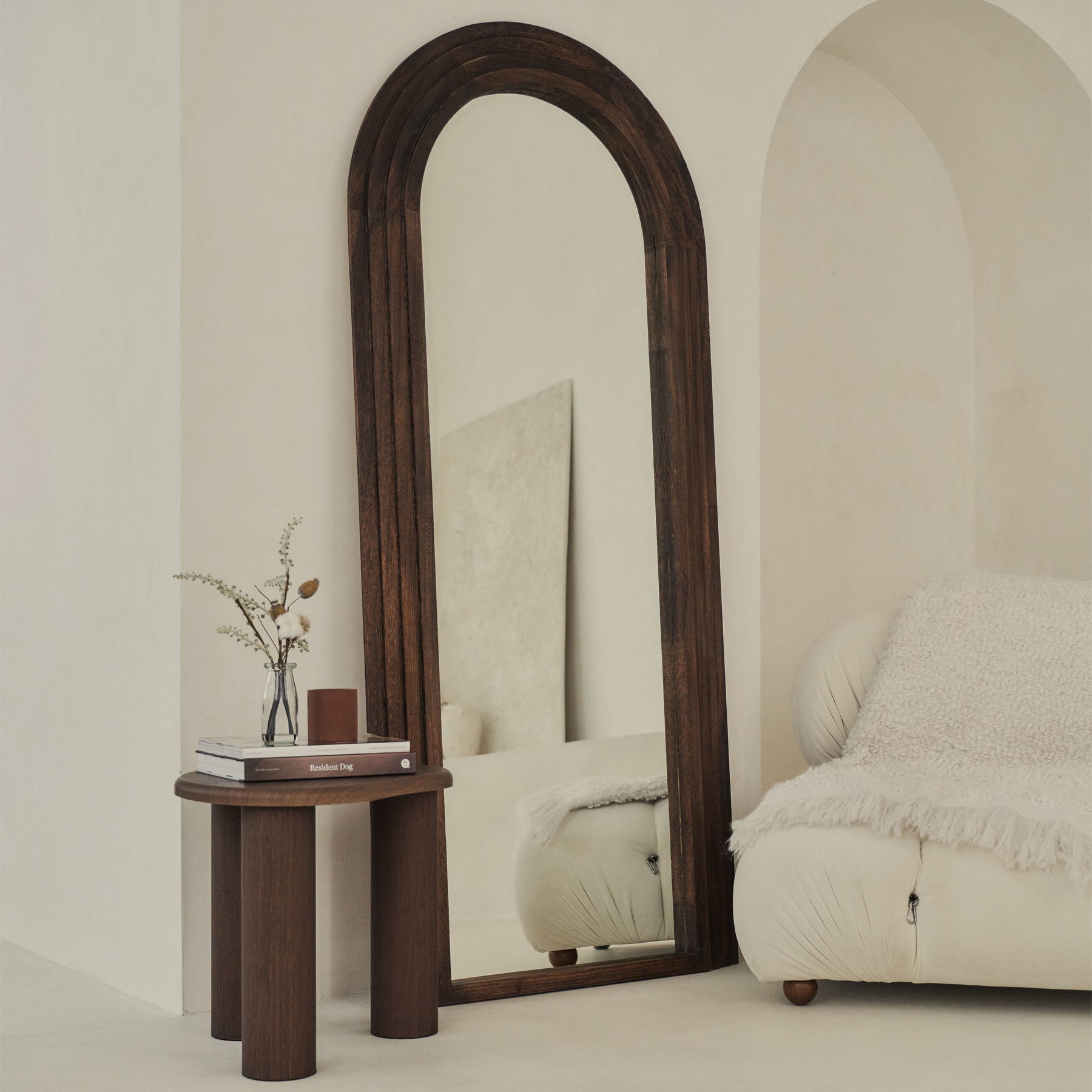 Full Length Arched Charred Wood Mirror leaning against wall, side table beside it