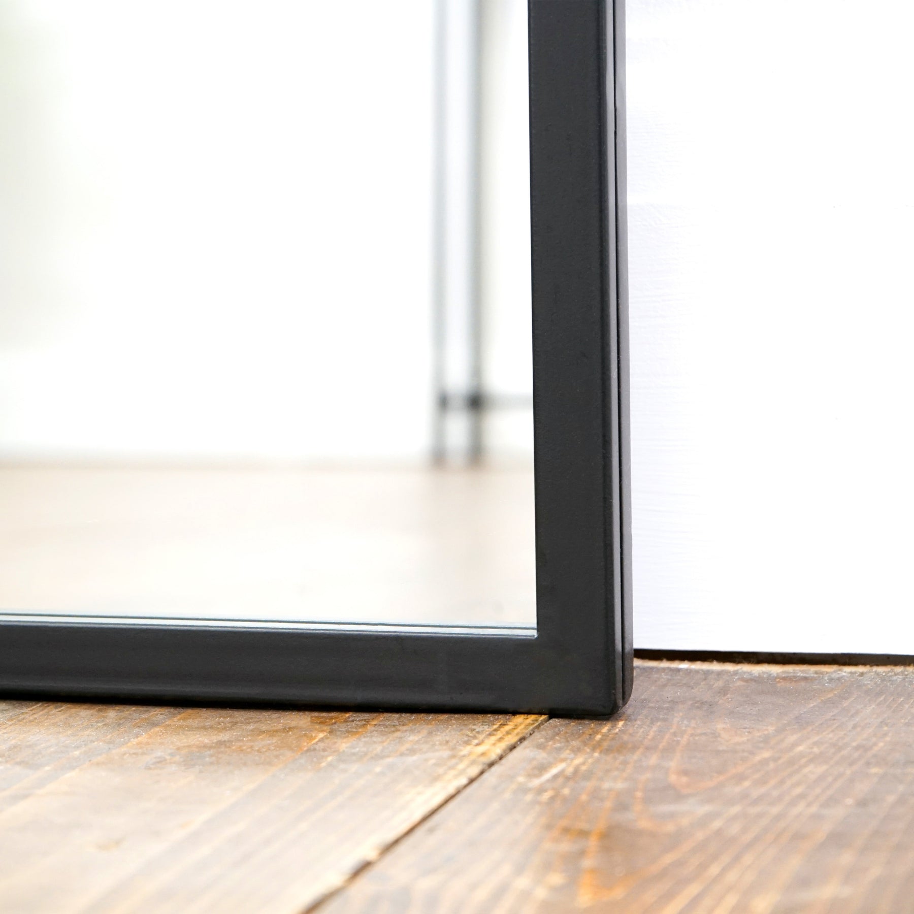 Closeup of Black industrial arched metal extra large mirror