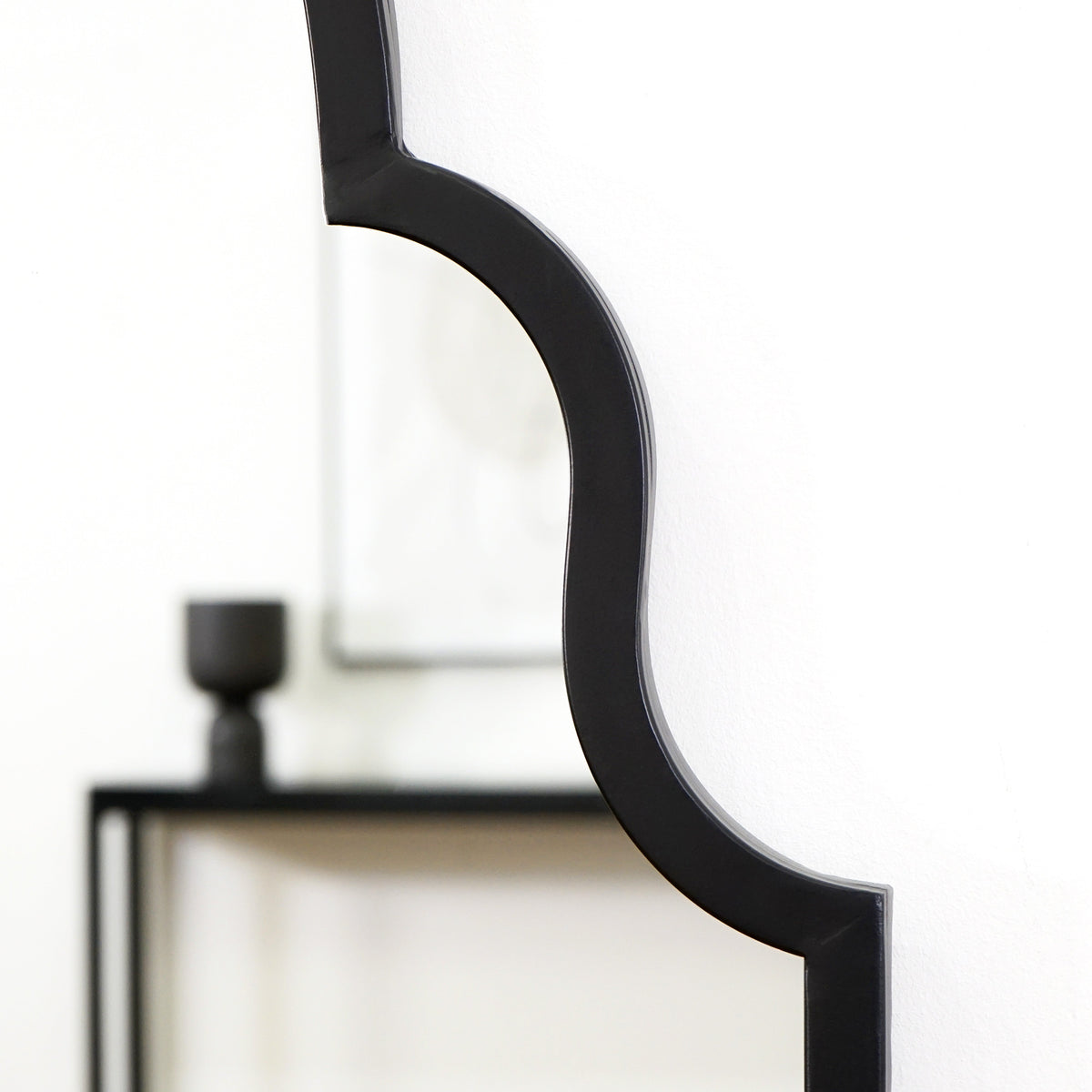 Closeup of Black industrial arched metal full length mirror