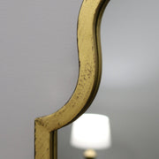 Closeup Gold industrial arched full length metal mirror
