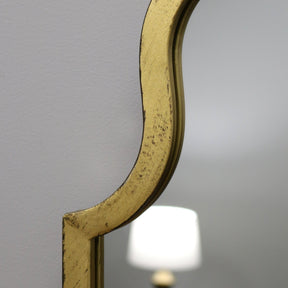 Closeup Gold industrial arched full length metal mirror