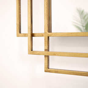 Closeup of gold rectangular geometric metal mirror