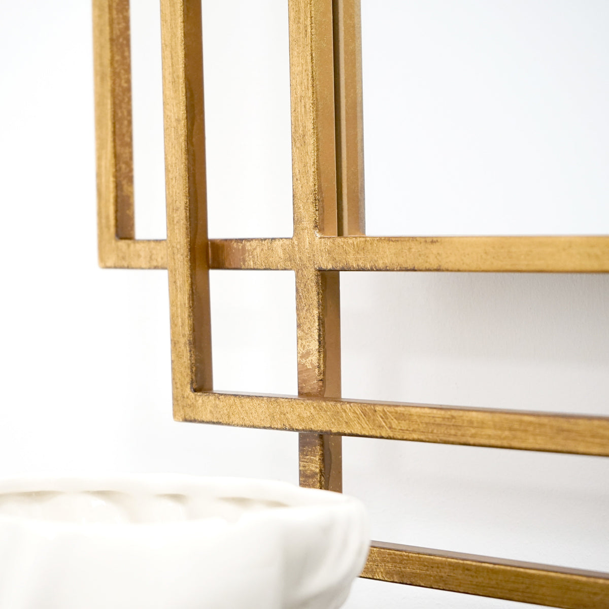 Closeup of Large gold rectangular metal mirror