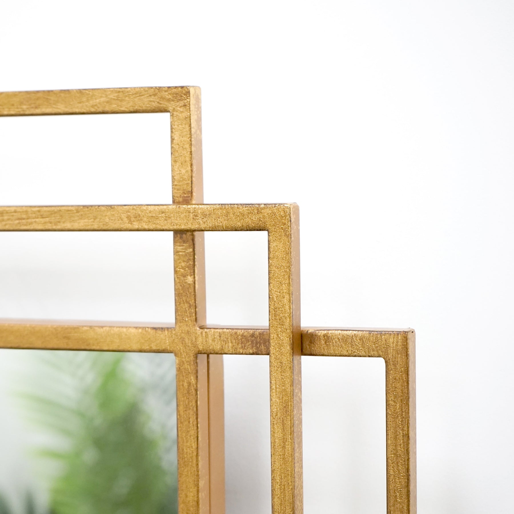 Closeup of Large gold rectangular metal mirror