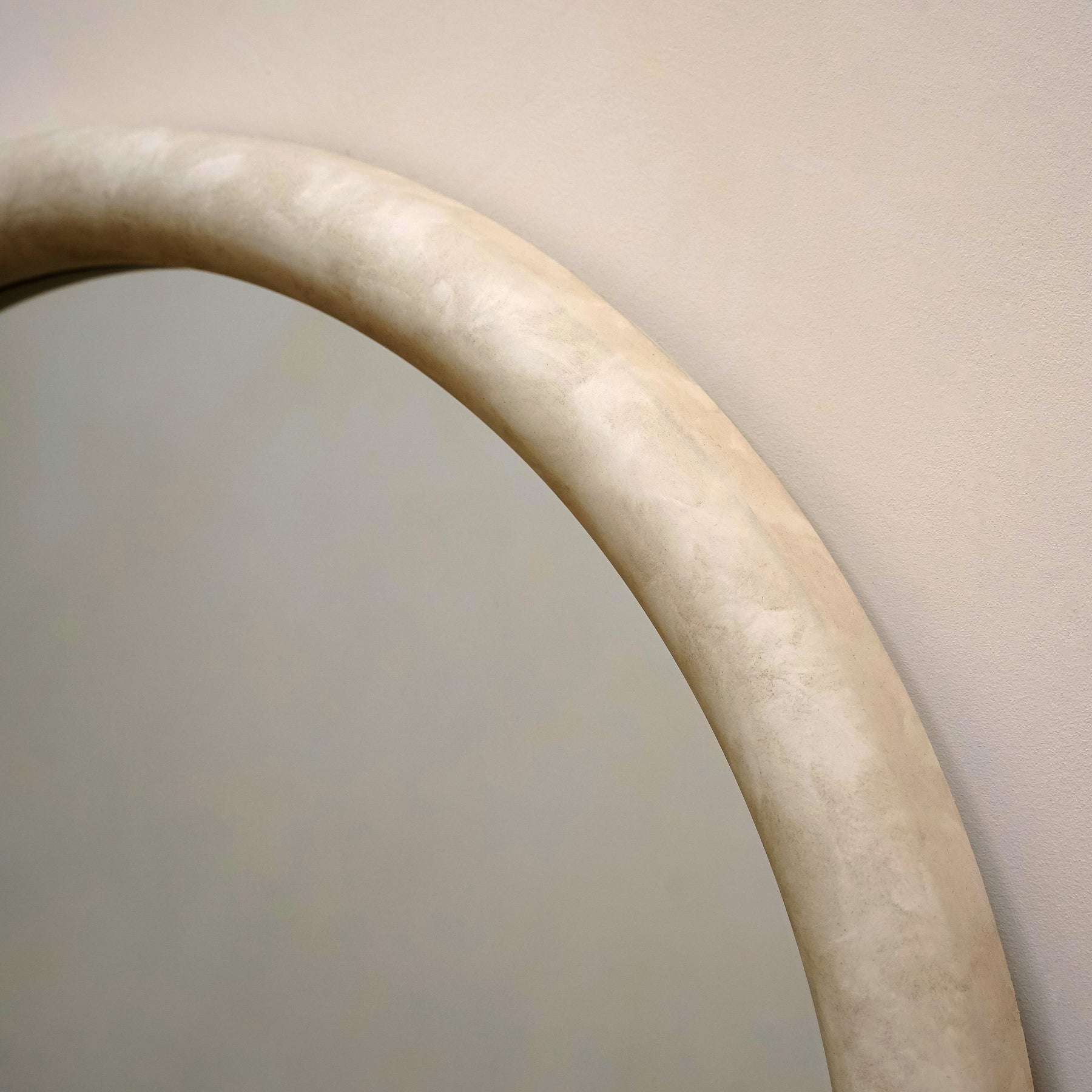 Closeup of Full length arched concrete mirror