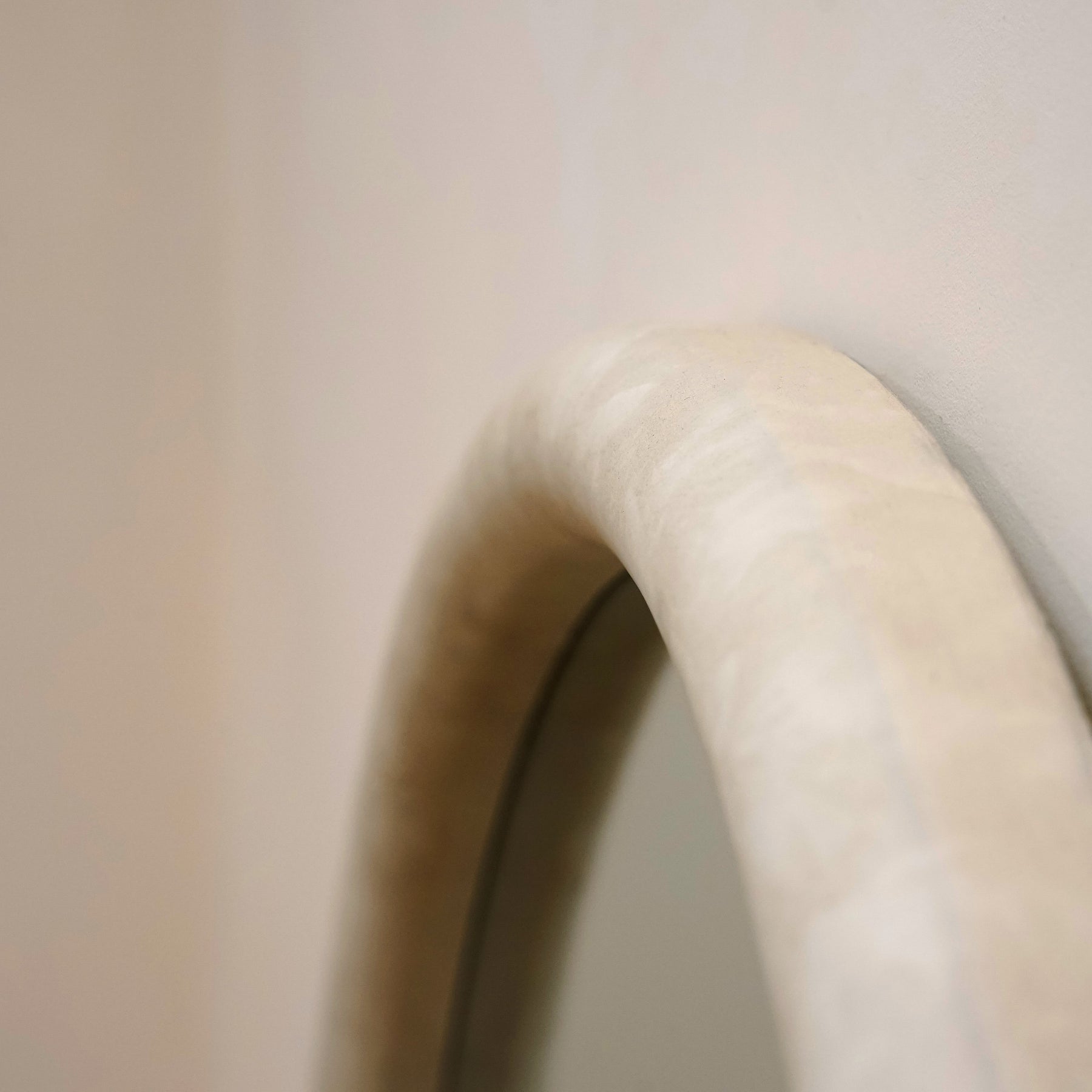 Closeup of Full length arched concrete mirror