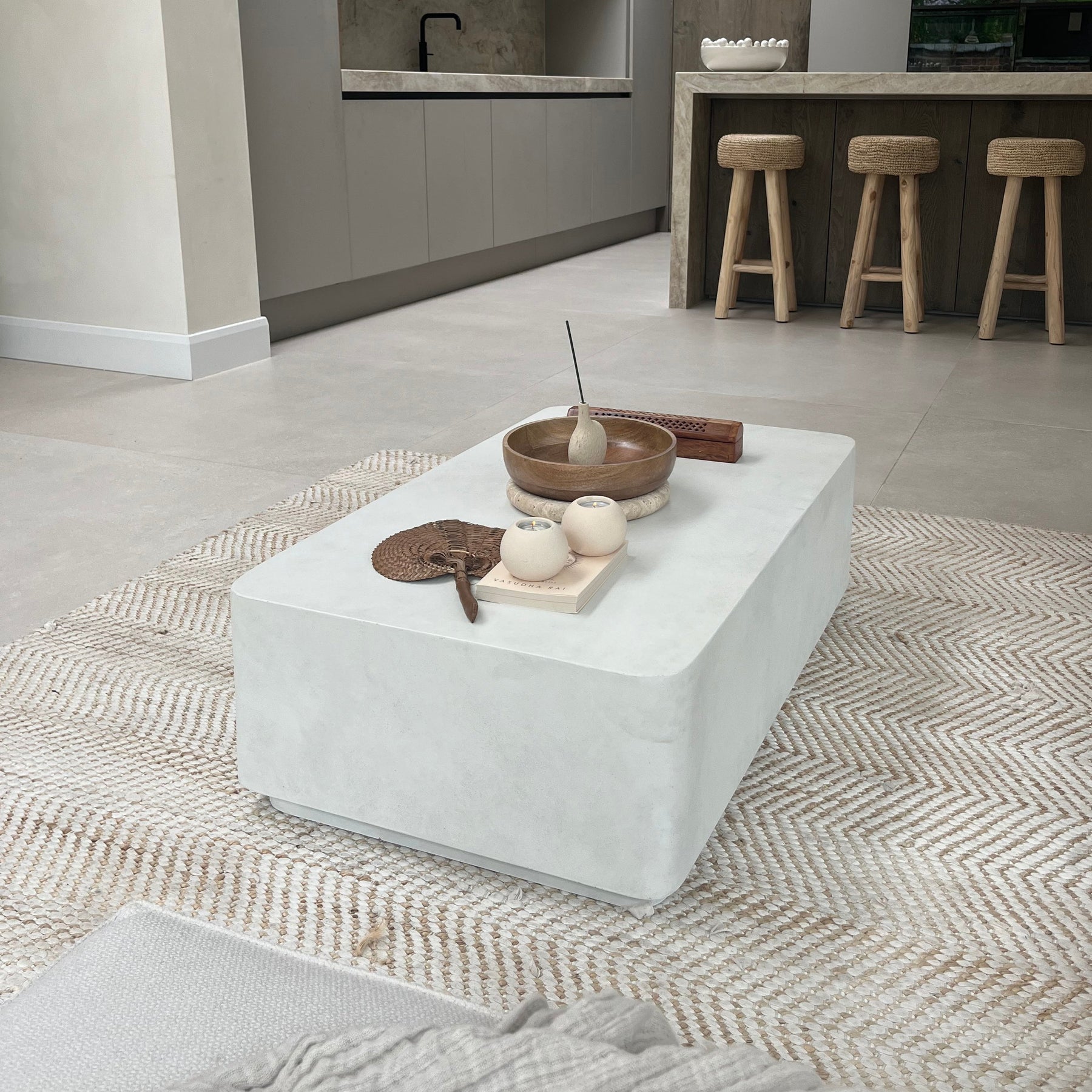 Minimal Concrete Rectangular Coffee Table Large on carpet, adorned with accessories