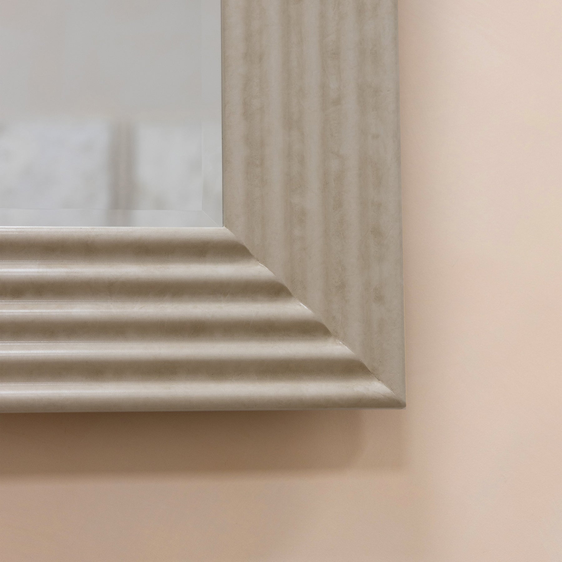 Large ribbed concrete console mirror closeup