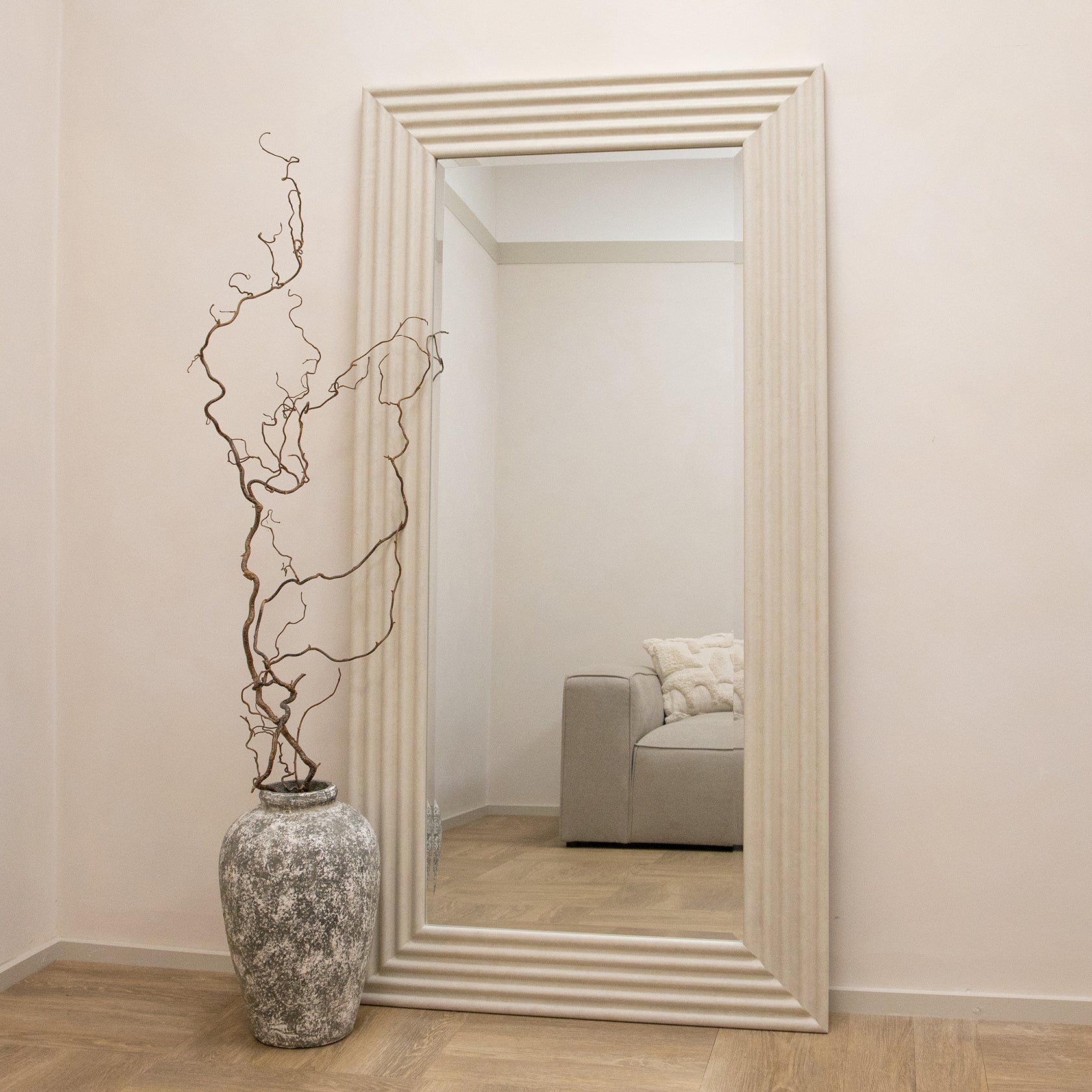 Full length ribbed concrete mirror leaning against wall