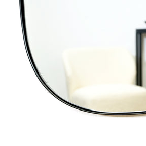 Black metal stone shaped irregular wall mirror closeup