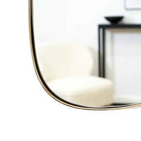 Gold metal stone shaped irregular wall mirror closeup