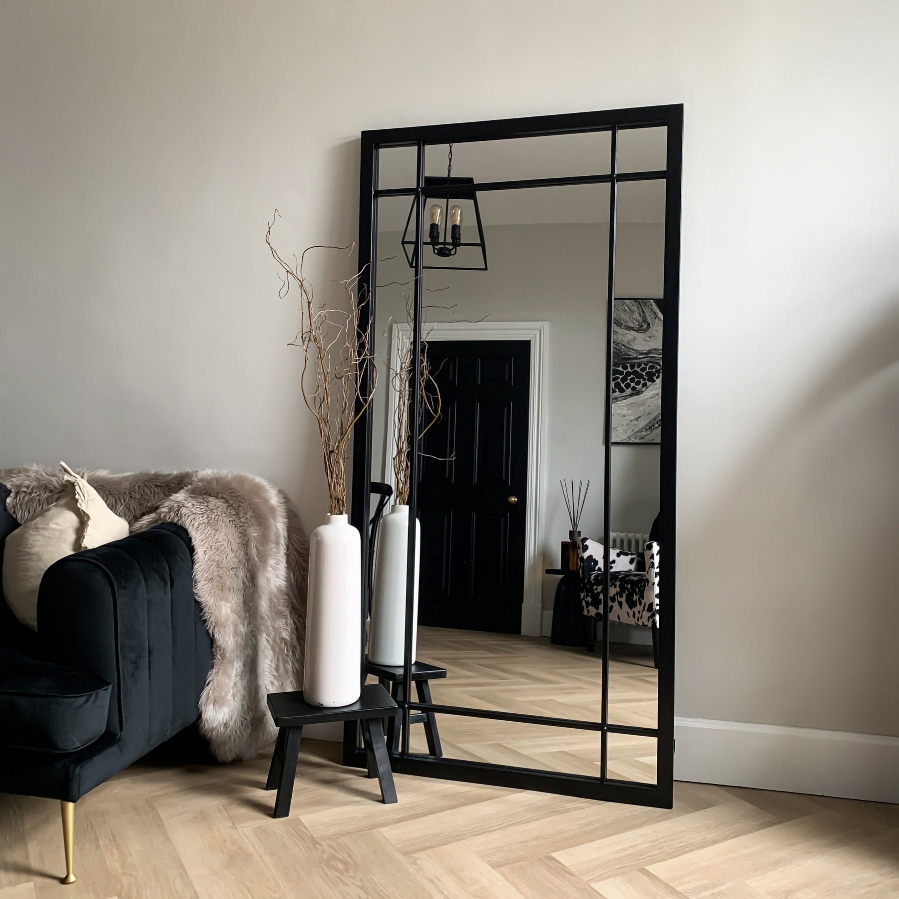 Black Industrial Full Length Metal Mirror leaning against wall