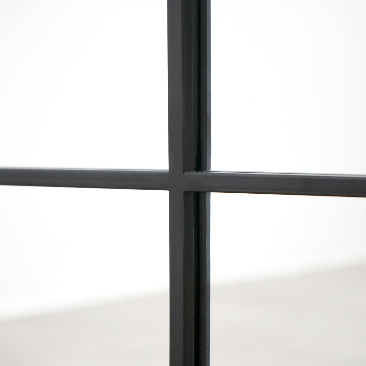 Closeup of Full length XL black industrial metal window mirror