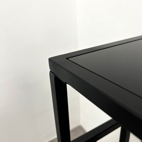 Detail shot of Black modern large rectangle tinted mirrored console table corner