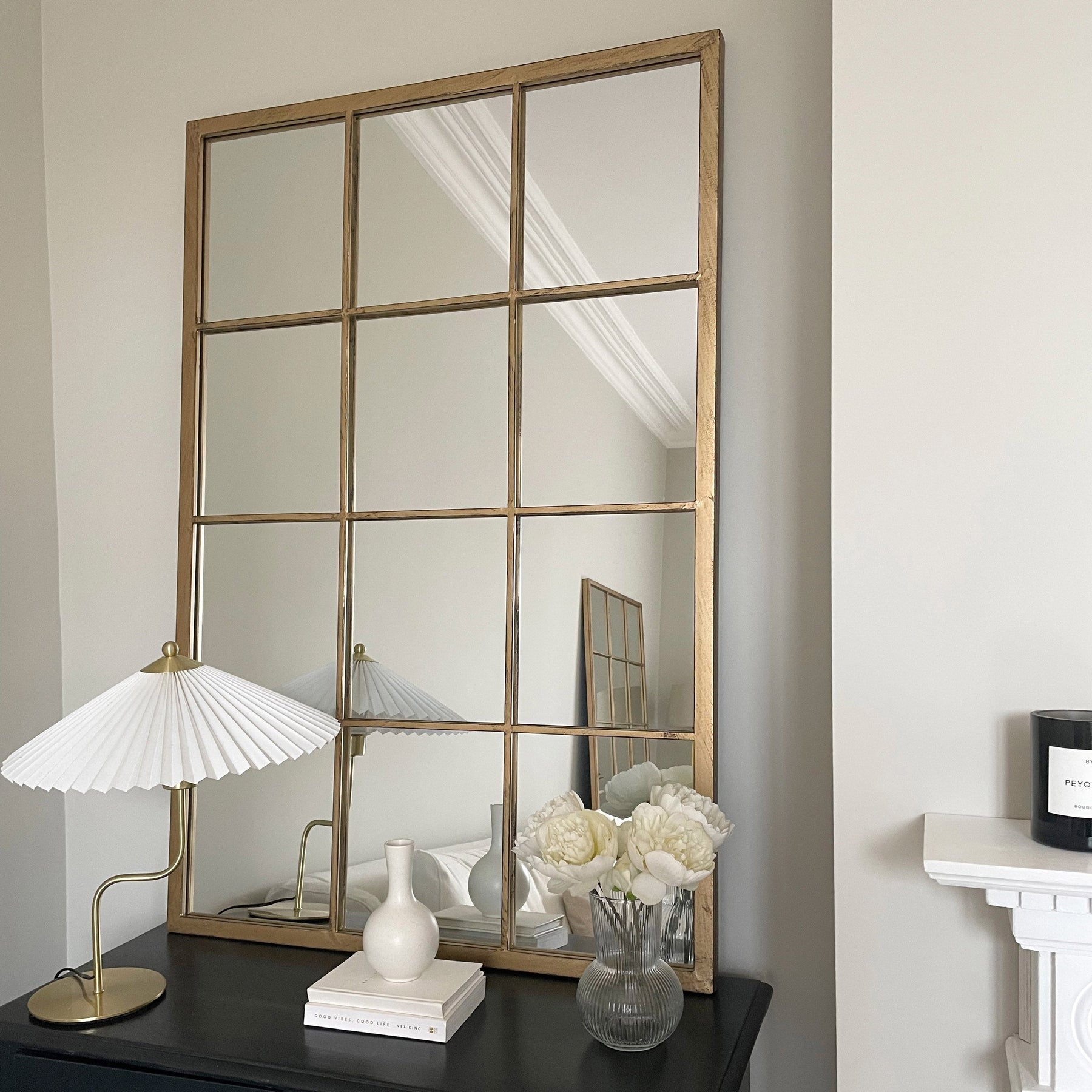 Large gold industrial metal window mirror leaning against wall