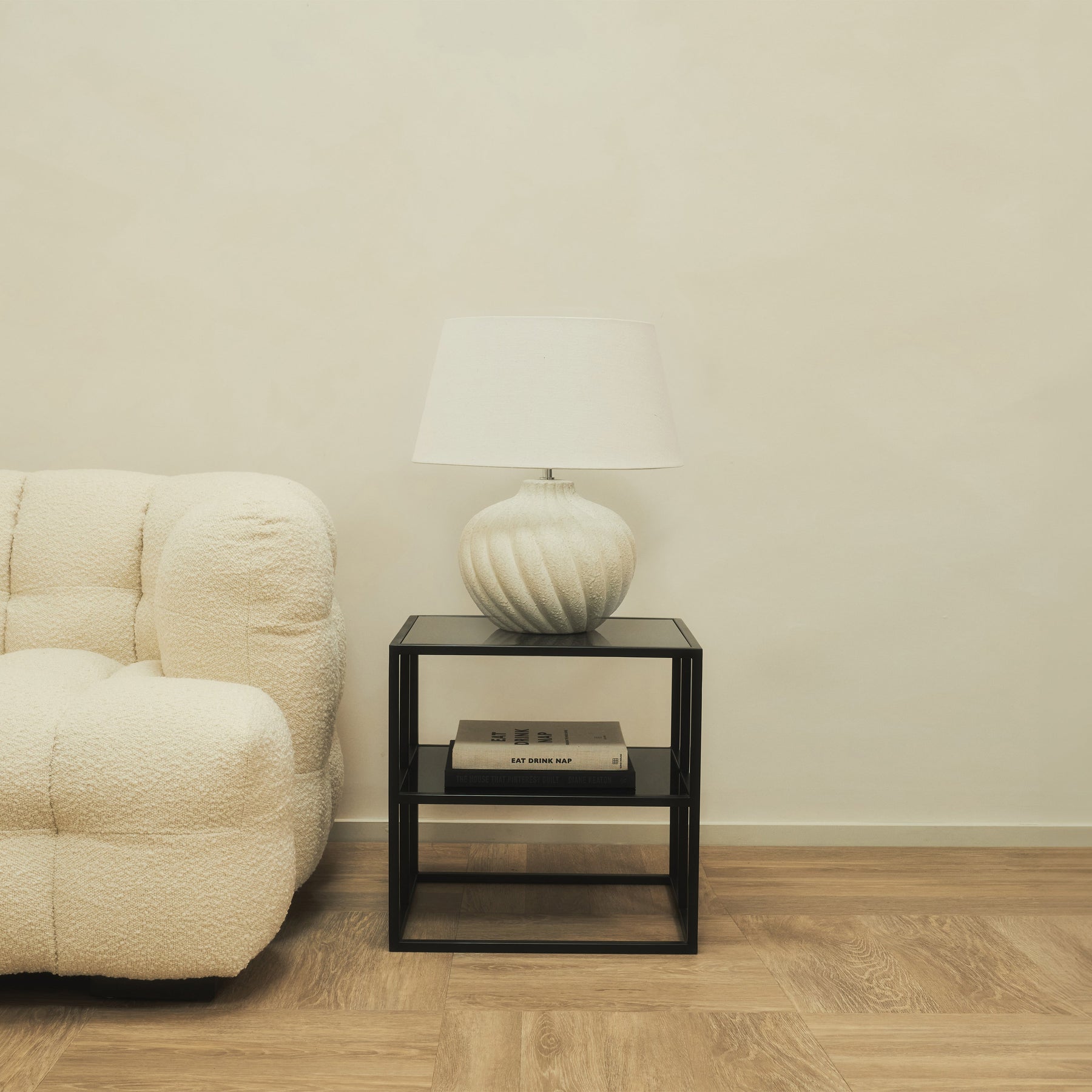 Textured ceramic based table lamp natural shade emitting warm lighting