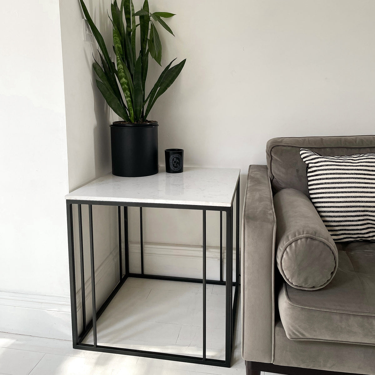 White marble effect rectangular side table beside sofa