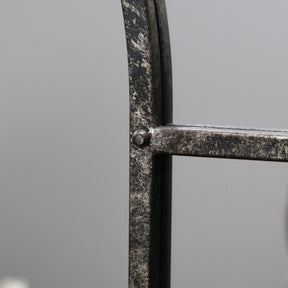 Crushed black industrial arched full length metal mirror detail shot of side
