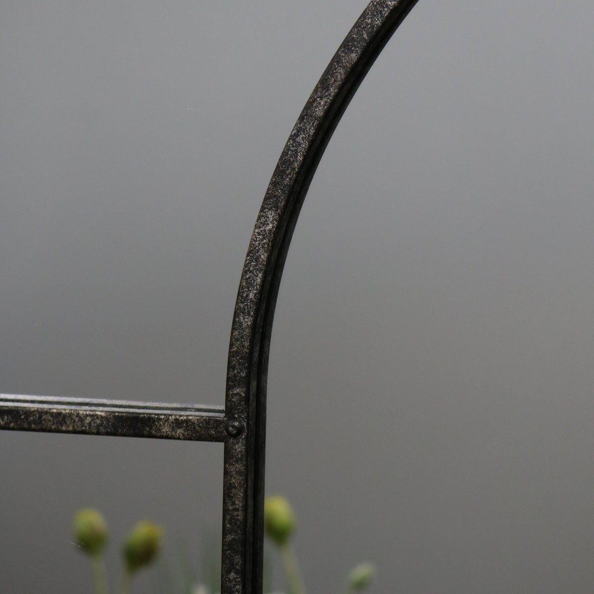 Crushed black industrial arched full length metal mirror detail shot of arch