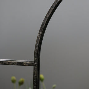 Crushed black industrial arched full length metal mirror detail shot of arch