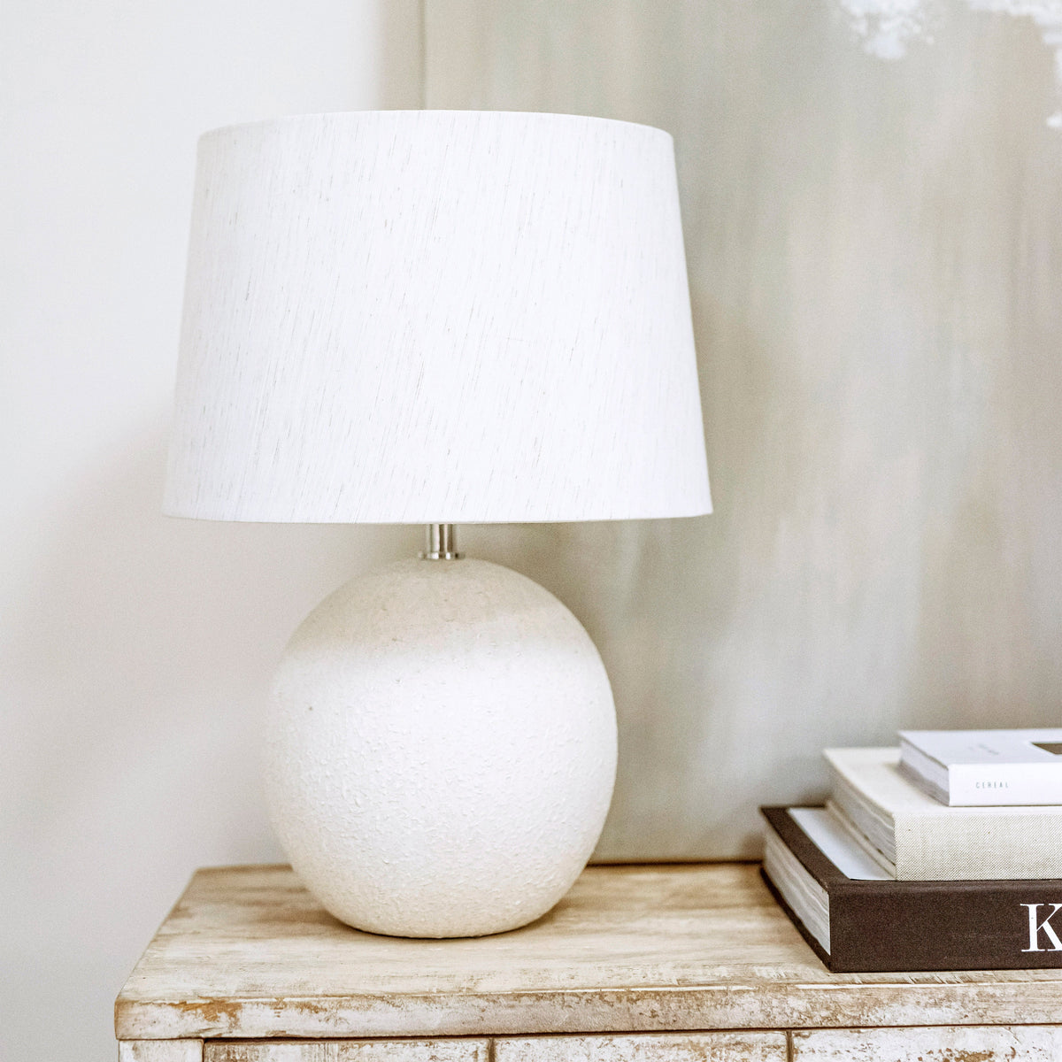 Stone ceramic drum shade table lamp on console table - off