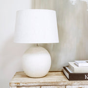 Stone ceramic drum shade table lamp on console table - off