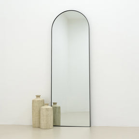 Full Length Black Arched Large Metal Mirror beside vase