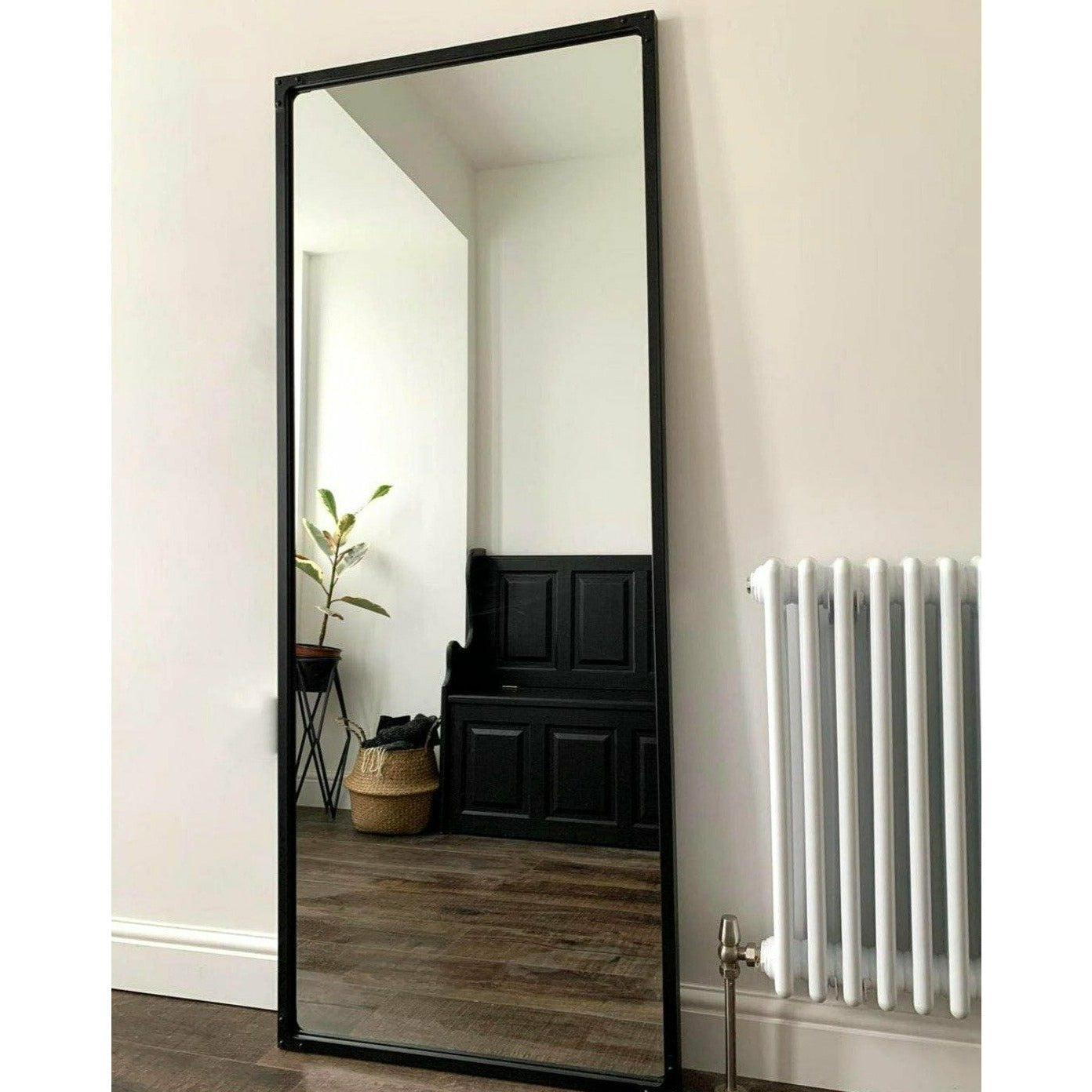 Black industrial full length metal mirror in hallway