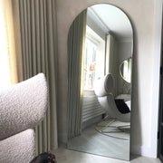 Large Frameless Arched Full Length Mirror reflecting natural light