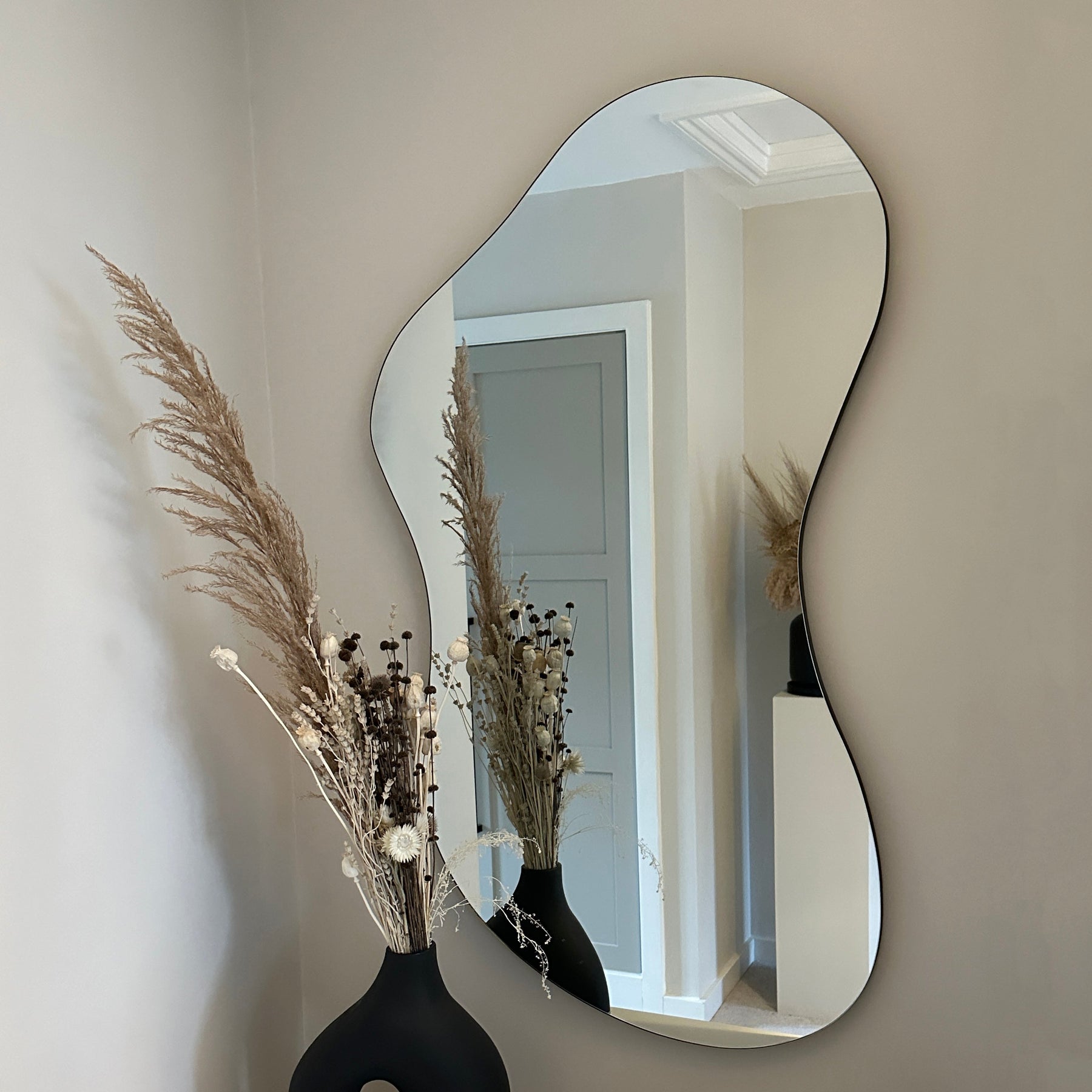 Medium Frameless Pond Mirror hanging on wall