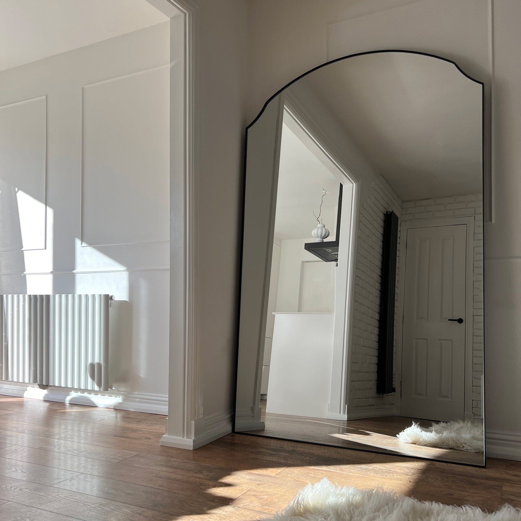 Black Full Length Arched Metal Mirror in living room