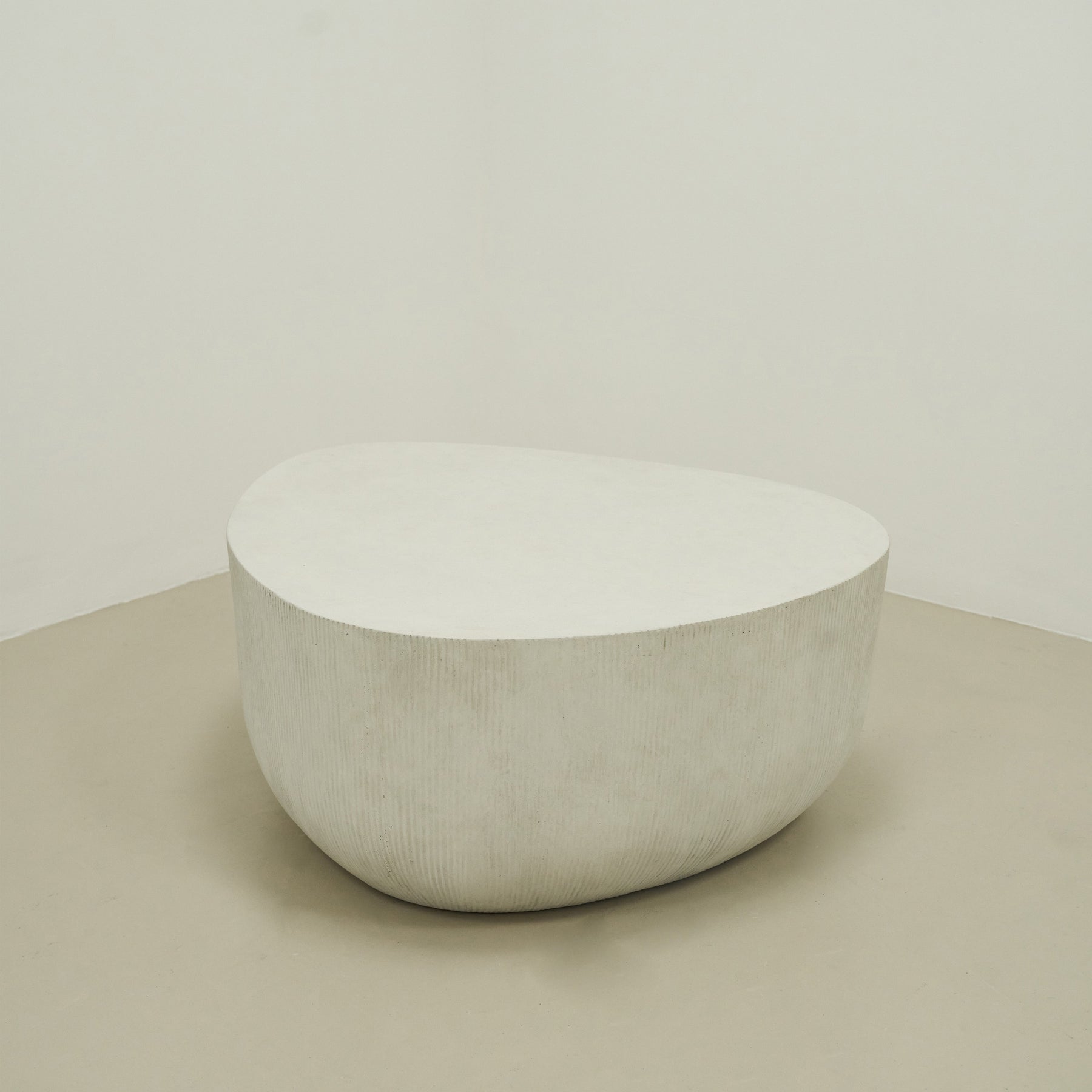 Minimal Concrete Irregular Shaped Coffee Table Large in muted room, empty