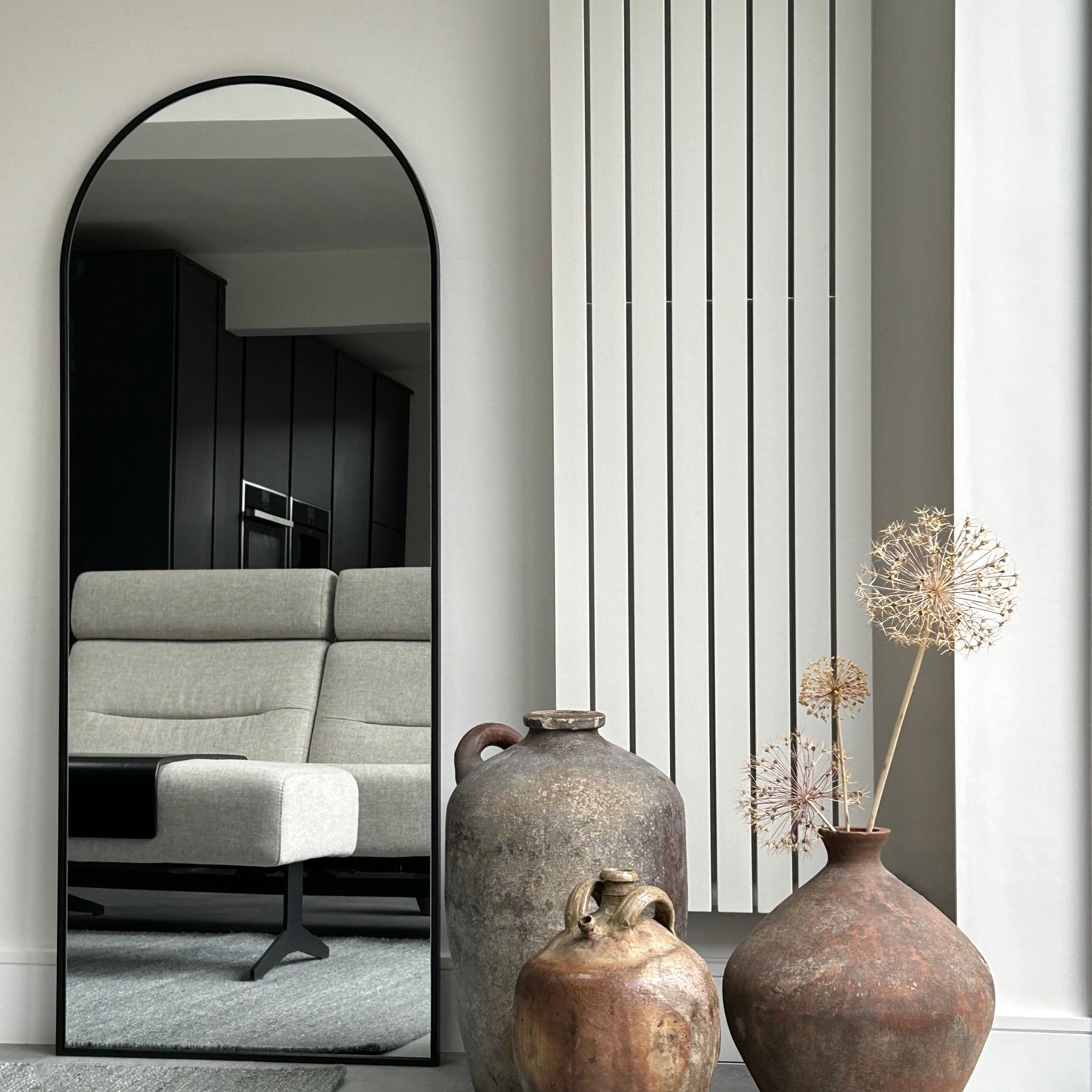 Black Full Length Arched Metal Mirror in living room