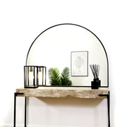 Black Wide Arched Metal Overmantle Mirror on console table