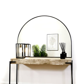 Black Wide Arched Metal Overmantle Mirror on console table