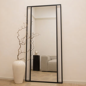 Full Length Black Metal Mirror beside vase