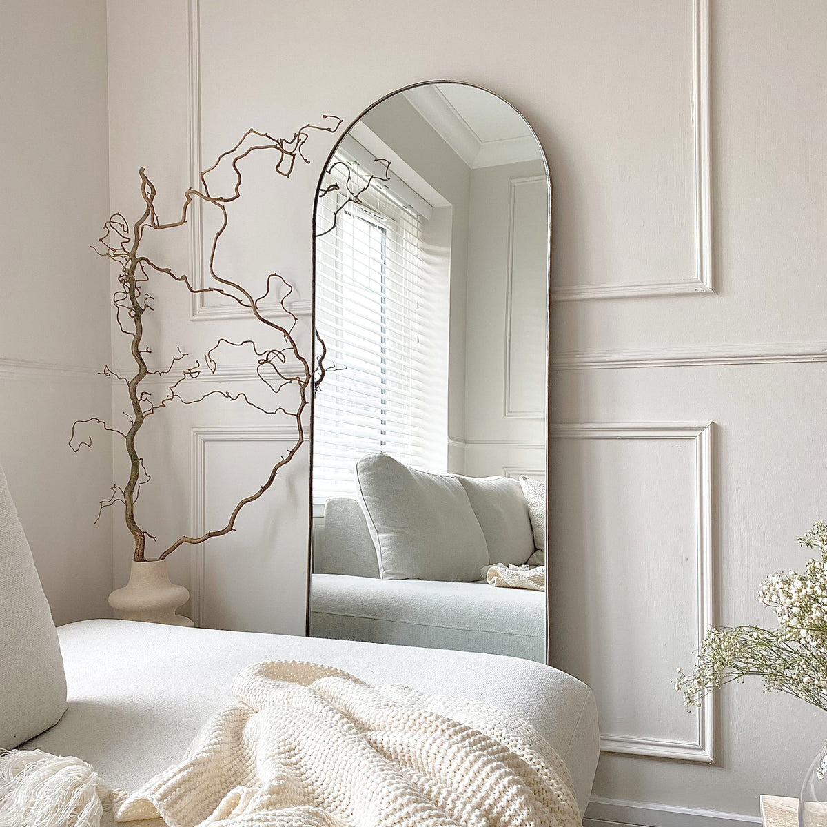 Full Length Gold Arched Large Metal Mirror adjacent to sofa