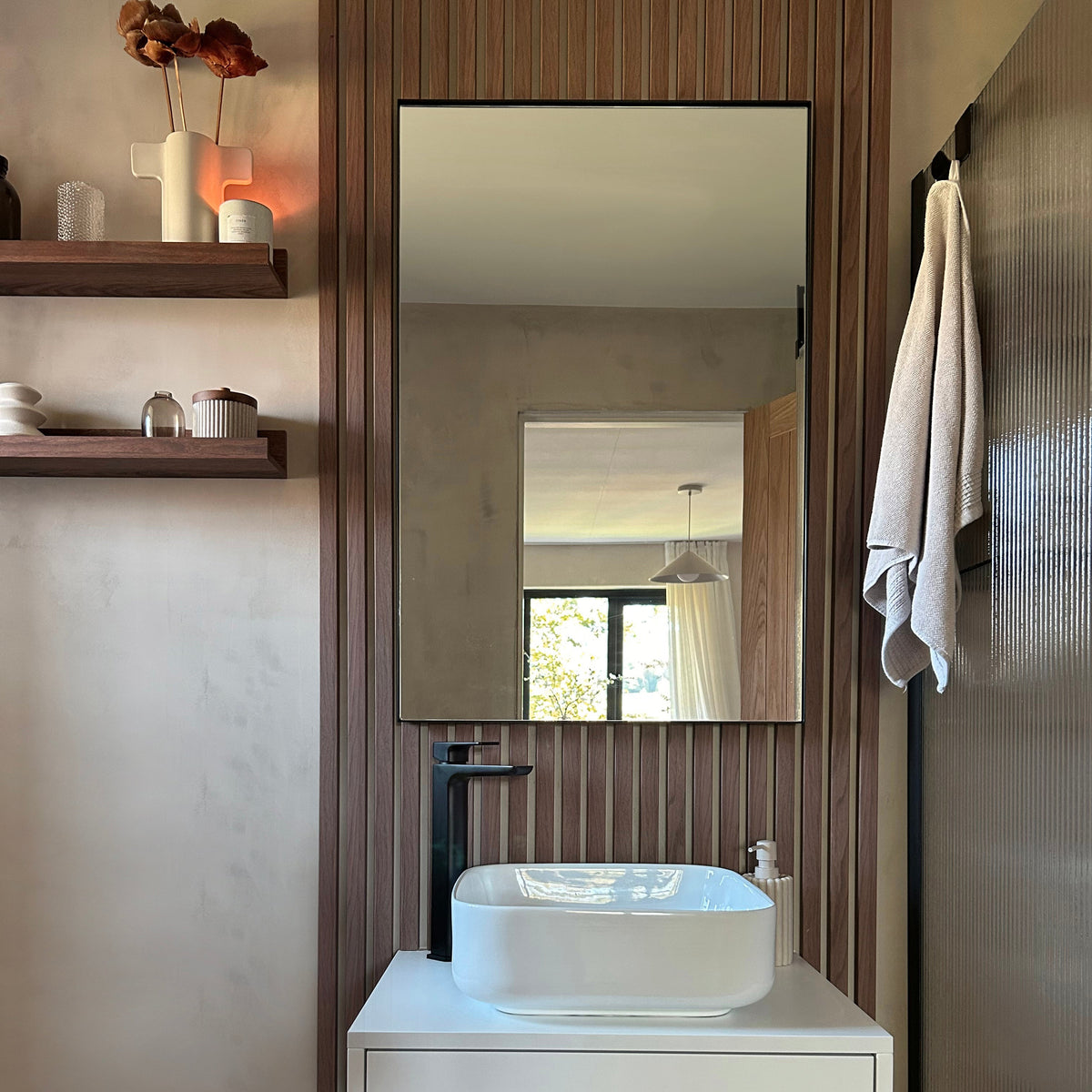 Black Rectangular Metal Wall Mirror on bathroom wall