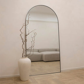 Full Length Black Arched Large Metal Mirror beside vase