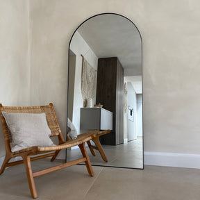 Full Length Black Arched Large Metal Mirror next to chair