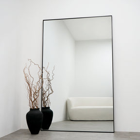 Full Length Black Extra Large Metal Mirror next to vase