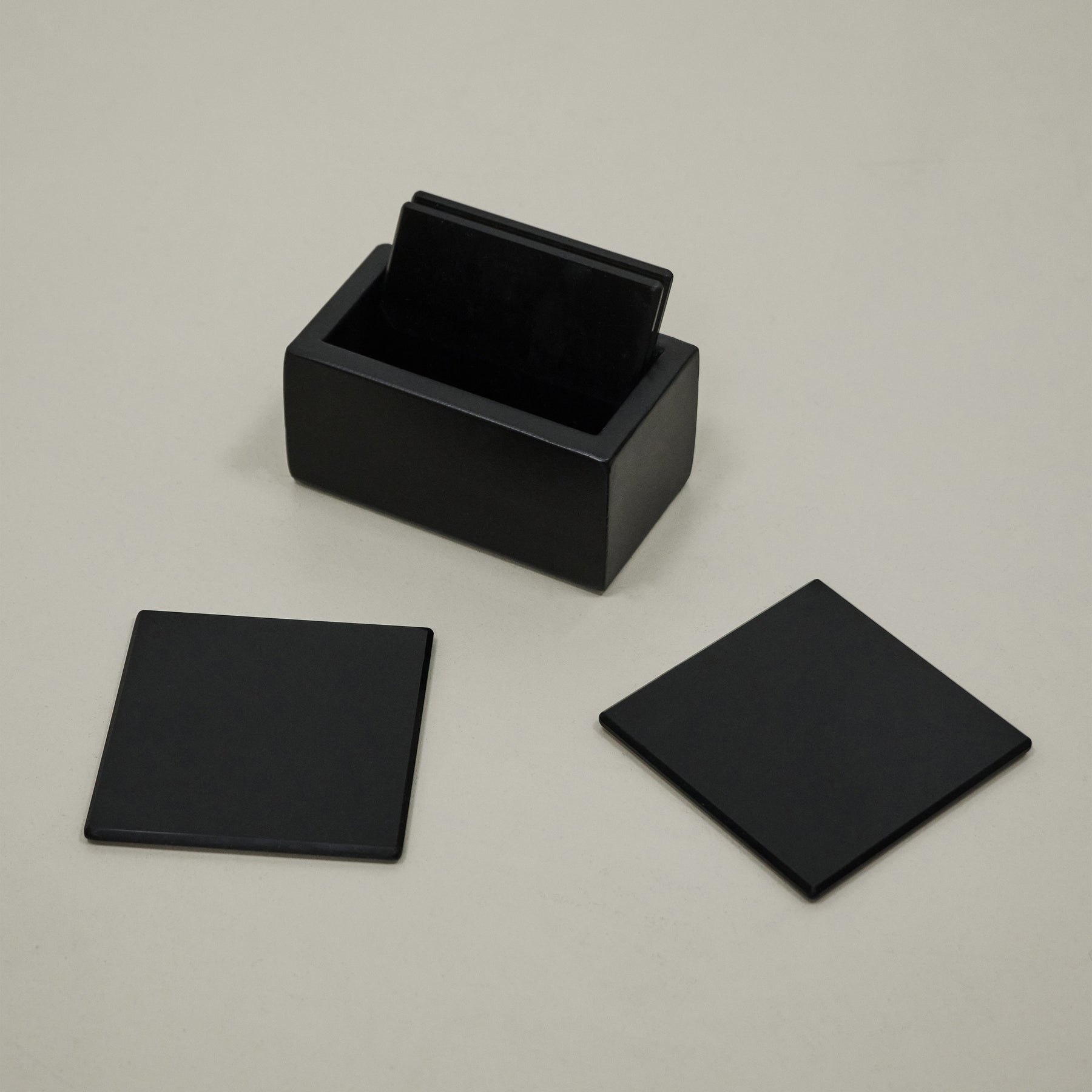 Black coasters on table