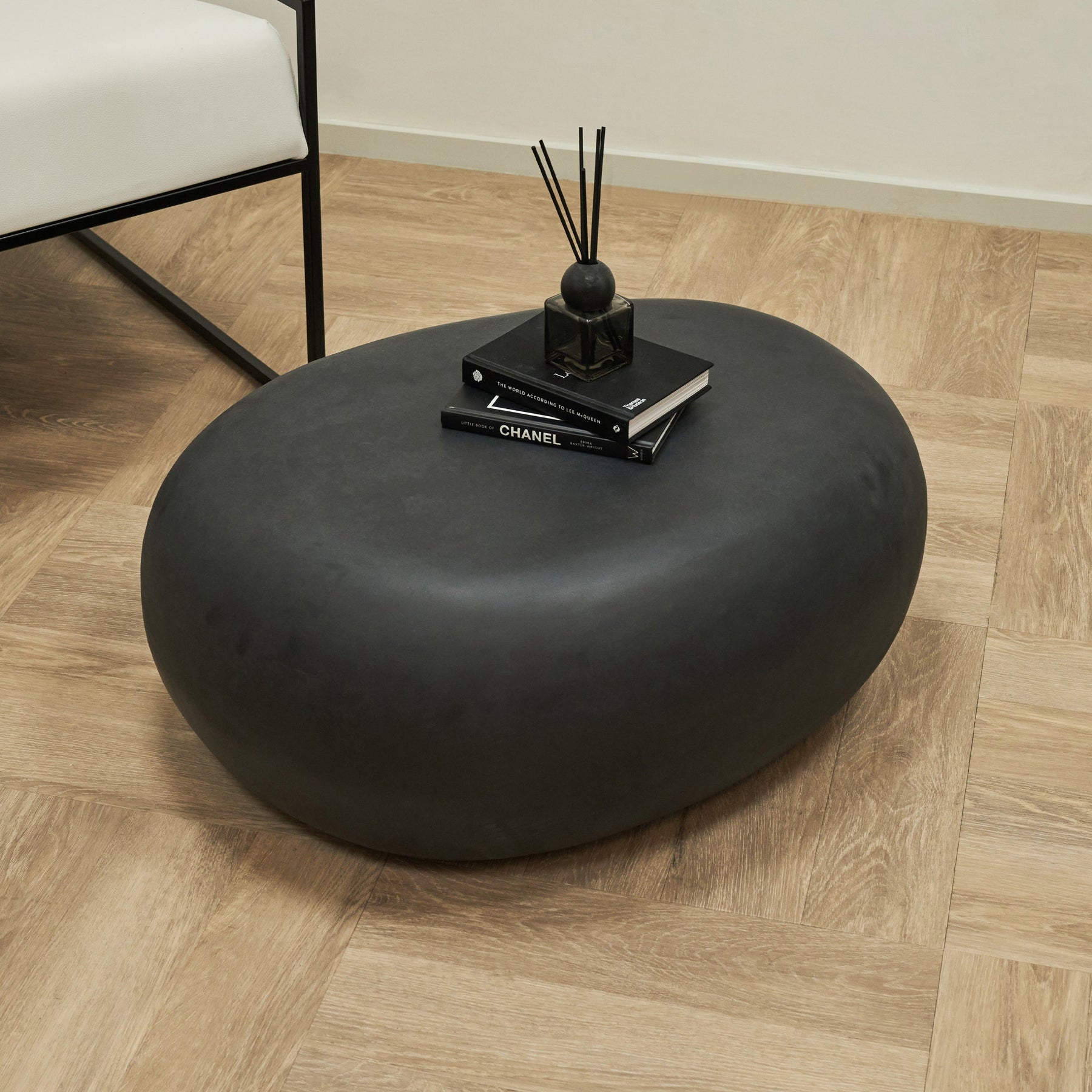 Minimal Onyx Pebble Coffee Table Large adorned with books and incense