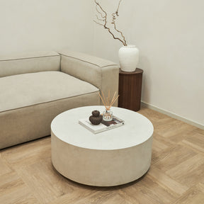 Large minimalist concrete round coffee table displayed in living room