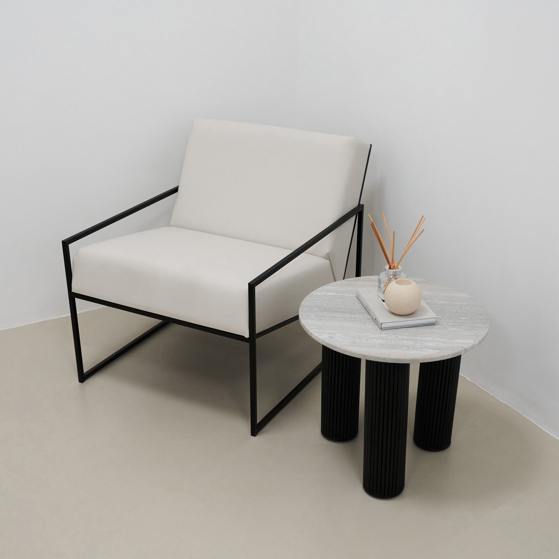 Travertine round side table beside chair