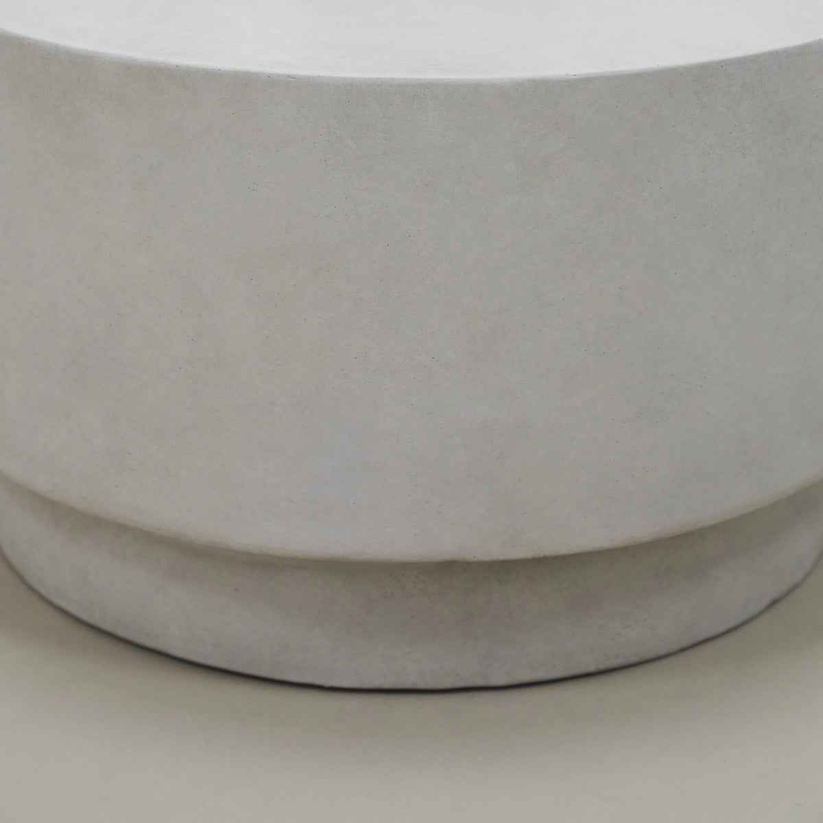 Closeup of Minimalist white concrete round coffee table