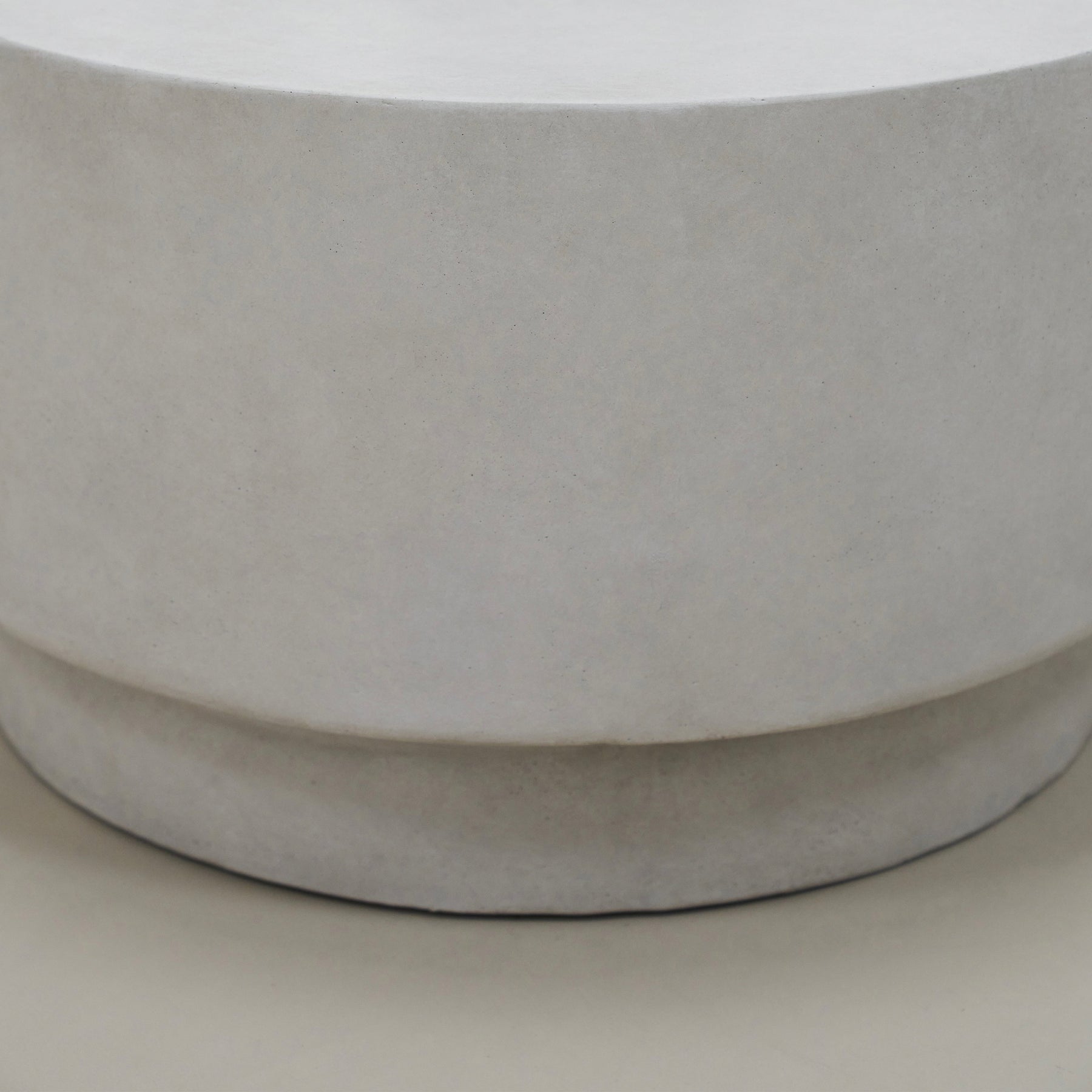 Closeup of Minimalist white concrete round coffee table