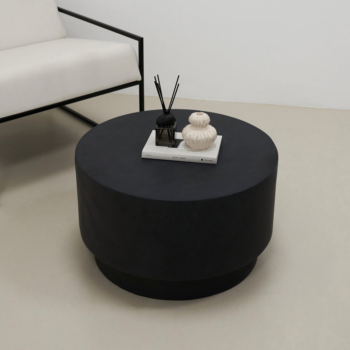 Minimal onyx round coffee table beside chair